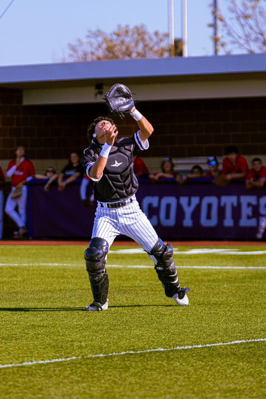 Aleck Hunte tracking a pop-up behind the plate in catcher's gear